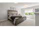 Bright bedroom with a large window, neutral walls, and a stylish upholstered bed frame at 408 Niles Ct, Marietta, GA 30060