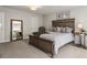 Serene bedroom showcasing a well-appointed bed, side table, mirror, and soft carpeting at 408 Niles Ct, Marietta, GA 30060