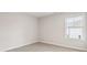 A sunlit bedroom showcases a neutral carpet, and a window with blinds at 408 Niles Ct, Marietta, GA 30060