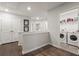 Hallway showcasing hardwood floors that lead to a laundry room at 408 Niles Ct, Marietta, GA 30060