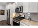 Stylish kitchen details including stainless steel appliances, granite countertops, and gray subway tile backsplash at 408 Niles Ct, Marietta, GA 30060