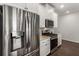 Close-up of a kitchen showcasing stainless steel fridge, gas range, and white cabinets at 408 Niles Ct, Marietta, GA 30060