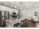 Modern kitchen features white cabinets, stainless steel appliances, a granite island, and pendant lighting at 408 Niles Ct, Marietta, GA 30060