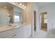 Bathroom with double sinks, white cabinets, marble floors, and a glass-enclosed shower at 600 Sidney Ct, Stockbridge, GA 30281