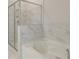 Bathroom with a shower and soaking tub that features marble-look tile at 600 Sidney Ct, Stockbridge, GA 30281
