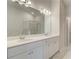 Bright bathroom with a double vanity, quartz countertop, a large mirror and modern lighting at 600 Sidney Ct, Stockbridge, GA 30281