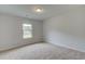 Inviting bedroom with neutral walls, plush carpeting, and a window providing ample natural light at 600 Sidney Ct, Stockbridge, GA 30281