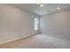 Neutral bedroom with carpet, recessed lighting, and a window for natural light at 600 Sidney Ct, Stockbridge, GA 30281