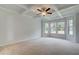 Large bedroom with coffered ceiling, neutral walls, carpet flooring, and multiple windows for natural light at 600 Sidney Ct, Stockbridge, GA 30281