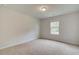 Comfortable carpeted bedroom featuring a window with views and a ceiling light fixture at 600 Sidney Ct, Stockbridge, GA 30281