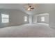 Expansive carpeted bonus room with vaulted ceiling and plenty of windows, offering versatile living space at 600 Sidney Ct, Stockbridge, GA 30281