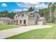 Two-story home showcasing an attached two-car garage and an extra garage on the side at 600 Sidney Ct, Stockbridge, GA 30281