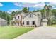 Stylish two-story home with attached garages, a blend of brick and siding, and manicured lawn at 600 Sidney Ct, Stockbridge, GA 30281