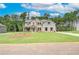 Two-story home featuring brick and siding, well-manicured lawn, and a welcoming front porch at 600 Sidney Ct, Stockbridge, GA 30281