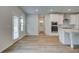 Bright kitchen with white cabinets, stainless steel appliances, wood floors, and a door to the patio at 600 Sidney Ct, Stockbridge, GA 30281