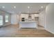 Bright kitchen with white cabinets, island, stainless steel appliances, and wood floors at 600 Sidney Ct, Stockbridge, GA 30281