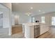 Open-concept living room and kitchen with wood floors and stainless steel dishwasher at 600 Sidney Ct, Stockbridge, GA 30281