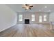 Spacious living room with hardwood floors, a cozy fireplace, and abundant natural light at 600 Sidney Ct, Stockbridge, GA 30281
