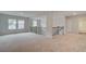 Expansive loft area with plush carpet, staircase with iron railing, and access to the bathroom at 600 Sidney Ct, Stockbridge, GA 30281