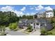 High aerial shot showcasing a scenic community with tree-lined streets and varied home styles at 1005 Coleman Place Dr, Roswell, GA 30075