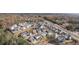 An autumn aerial view of a neighborhood with mature trees and a mix of housing styles at 1005 Coleman Place Dr, Roswell, GA 30075