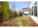 Backyard featuring newly installed sod, privacy landscaping, and covered porch at 1005 Coleman Place Dr, Roswell, GA 30075