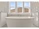 Luxurious soaking tub in a bright bathroom at 1005 Coleman Place Dr, Roswell, GA 30075