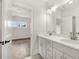 Bright bathroom with double vanity, white cabinets, quartz countertops, and modern lighting at 1005 Coleman Place Dr, Roswell, GA 30075