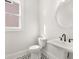 Charming powder room with pedestal sink, patterned tile floors, and natural light from the window at 1005 Coleman Place Dr, Roswell, GA 30075