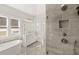 Bathroom showcasing a glass shower with gray tile, dual shower heads, and a built in niche at 1005 Coleman Place Dr, Roswell, GA 30075