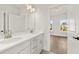 Bright bathroom with double sink vanity, white cabinets, quartz countertop and a view into an adjacent room at 1005 Coleman Place Dr, Roswell, GA 30075
