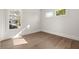 Bedroom with hardwood floors and natural light from two large windows at 1005 Coleman Place Dr, Roswell, GA 30075
