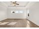 Bright, expansive bedroom featuring hardwood floors, tray ceiling and large windows at 1005 Coleman Place Dr, Roswell, GA 30075