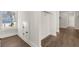 Walk-in closet with hardwood floors, a window, and a hidden door at 1005 Coleman Place Dr, Roswell, GA 30075