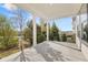 Relaxing covered patio with white columns overlooking lush landscaping and neighborhood views at 1005 Coleman Place Dr, Roswell, GA 30075