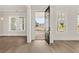 Open-concept entryway featuring hardwood floors, white trim, and lots of natural light at 1005 Coleman Place Dr, Roswell, GA 30075