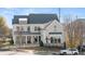 Beautiful two-story home featuring large windows, covered porch, dormers, and professional landscaping at 1005 Coleman Place Dr, Roswell, GA 30075