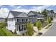 Elegant two-story home featuring black shutters, a covered porch, and manicured landscaping at 1005 Coleman Place Dr, Roswell, GA 30075