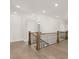 Bright hallway with hardwood floors and staircase featuring decorative iron railings at 1005 Coleman Place Dr, Roswell, GA 30075