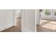 Hallway featuring hardwood floors with access to living room with fireplace at 1005 Coleman Place Dr, Roswell, GA 30075