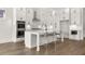 New kitchen featuring white cabinets, stainless appliances, a center island, and barstool seating at 1005 Coleman Place Dr, Roswell, GA 30075