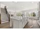 Open-concept kitchen features stainless steel appliances, large island with seating, and hardwood floors at 1005 Coleman Place Dr, Roswell, GA 30075