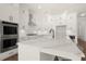 Modern kitchen with white cabinets, stainless steel appliances, and center island at 1005 Coleman Place Dr, Roswell, GA 30075