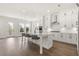 Open concept kitchen with white cabinets, stainless steel appliances, and center island at 1005 Coleman Place Dr, Roswell, GA 30075