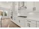 Modern kitchen with white cabinets, subway tile backsplash, and stainless steel appliances at 1005 Coleman Place Dr, Roswell, GA 30075