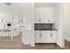 Modern kitchen featuring custom white cabinets, stainless steel appliances, and marble countertops at 1005 Coleman Place Dr, Roswell, GA 30075