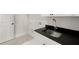 Functional laundry room with sleek countertops, a sink, and convenient storage at 1005 Coleman Place Dr, Roswell, GA 30075