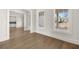 Sunlit living room showcasing hardwood floors, large windows, and neutral color palette at 1005 Coleman Place Dr, Roswell, GA 30075