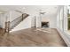 The expansive living area showcases hardwood floors, a modern fireplace, and a staircase with wrought iron railings at 1005 Coleman Place Dr, Roswell, GA 30075