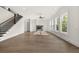 The spacious living area offers hardwood floors, a modern fireplace, and a staircase with wrought iron railings at 1005 Coleman Place Dr, Roswell, GA 30075